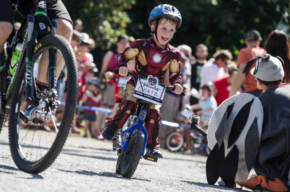 young bike racer dressed up like Ironman