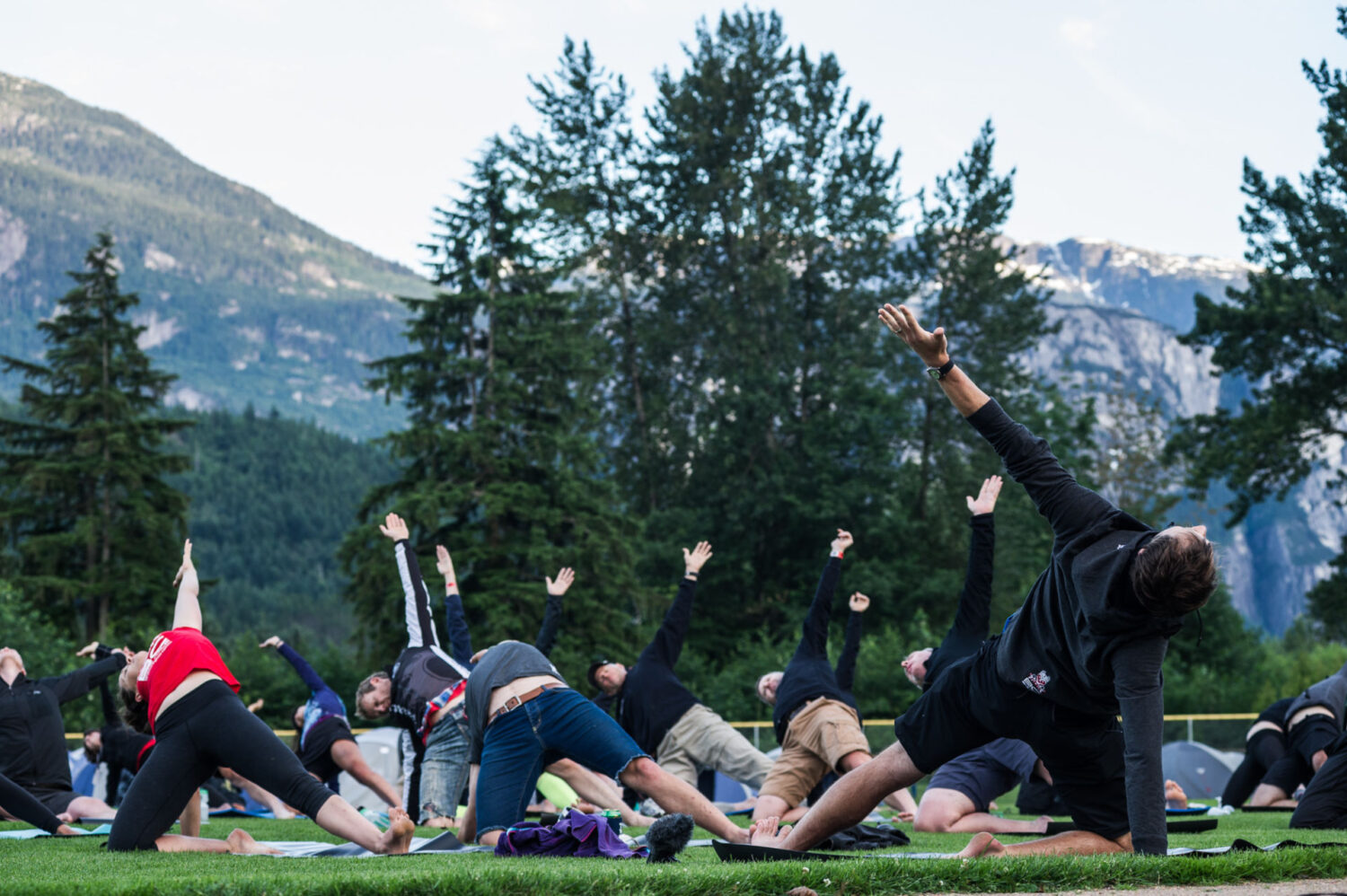 racers doing yoga in a field