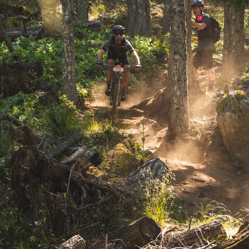 mountain biker navigating rocky, rooty terrain