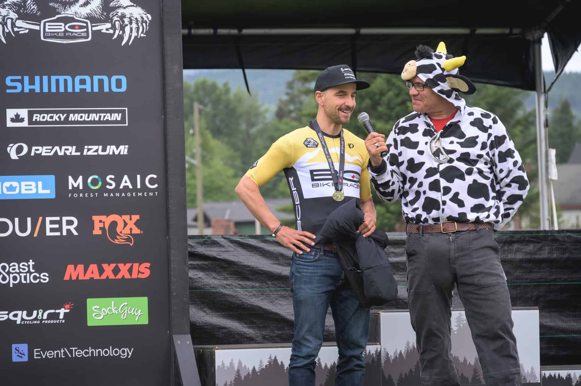 Brett Tippie, dressed in a Cow costume, interviews Nino Schurter